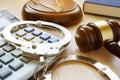 Handcuffs, gavel and calculator. Financial fraud.