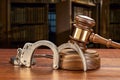 Handcuffs and gavel in law library Royalty Free Stock Photo