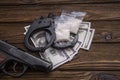 Handcuffs, a gun, money and drugs on a wooden table Royalty Free Stock Photo