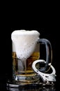 Handcuffs on the handle of a beer mug Royalty Free Stock Photo