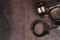 Handcuffs and judge gavel on wooden background