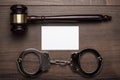 Handcuffs and judge gavel on wooden background Royalty Free Stock Photo