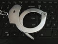 Handcuffs on the keyboard. Enter button. English Royalty Free Stock Photo