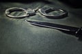 Handcuffs and knife on a black table. Violence, murder, military concept