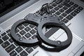 Handcuffs on laptop keyboard. Copyright concept 3d Royalty Free Stock Photo