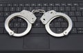 Handcuffs on laptop keyboard Royalty Free Stock Photo