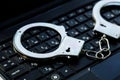 handcuffs on the laptop keyboard. hacker crimes Royalty Free Stock Photo