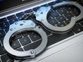 Handcuffs on the laptop keyboard. Internet cyber crime, hacking Royalty Free Stock Photo