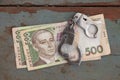 Handcuffs lie on a 500 hryvnia bill on a wooden table