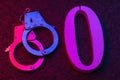 Handcuffs and number zero on a stone surface close-up. Concept on the topic of zeroing prison terms Royalty Free Stock Photo