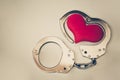 Handcuffs with a red love heart Royalty Free Stock Photo