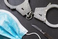 Handcuffs, scalpel and medical mask on the table. Medical error concept Royalty Free Stock Photo