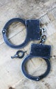 Handcuffs On Wood Royalty Free Stock Photo