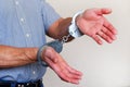 Handcuffs on the wrists of the detained man Royalty Free Stock Photo