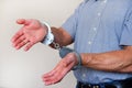 Handcuffs on the wrists of the detained man Royalty Free Stock Photo