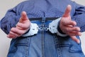 Handcuffs on the wrists of the detained man Royalty Free Stock Photo