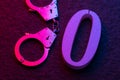 Handcuffs and zero on the surface of the stone. Concept on the topic of zeroing the terms of imprisonment Royalty Free Stock Photo