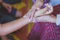 Handfasting. Selective focus on hands of Thai graduation ceremony.