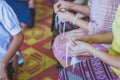 Handfasting. Selective focus on hands of Thai graduation ceremony.