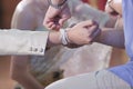 Handfasting. Selective focus on hands of Thai wedding ceremony. Royalty Free Stock Photo