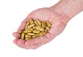 Handful of brown spotted vitamins in male hand Royalty Free Stock Photo