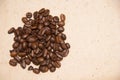 A handful of coffee beans on a beige background. Wrapping paper Royalty Free Stock Photo