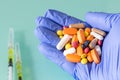 A handful of different colored drugs in the hand of a doctor.  The concept of abuse of supplements and vitamins Royalty Free Stock Photo