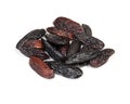 Handful of dried tonka beans closeup on white