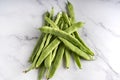 A handful of green beans isolated on white marble background Royalty Free Stock Photo