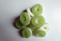 Handful of green and white sugar coated jelly ring candies