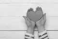 Handful of love, close up. Female hands holding red paper heart, top view Royalty Free Stock Photo
