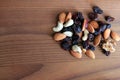 Handful of nuts,raisins and cranberries on wood background