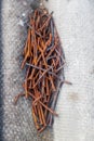 A handful of old bent rusty nails on a piece of slate