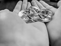 Handful palms of bitcoins in black and white, holding cryptocurrencies as a promising investment and future main currency on the Royalty Free Stock Photo