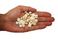 Handful of pills in palm of hand on white background, close-up. Royalty Free Stock Photo