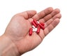 Different pills in the hands of a man close up on a white background Royalty Free Stock Photo