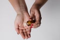 A handful of pills are poured into the girl`s hand