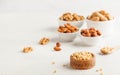 A handful of pine nuts in a wooden bowl, assorted nuts on a light background. Healthy snacks, healthy fats. Copy space