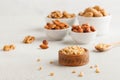 A handful of pine nuts in a wooden bowl, assorted nuts on a light background. Healthy snacks, healthy fats. Copy space Royalty Free Stock Photo