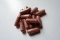 Handful of pink capsules of PQQ supplement Royalty Free Stock Photo