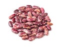 Handful of red spotted pinto bean closeup on white