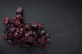 Handful of red sun-dried cranberries on black background Royalty Free Stock Photo