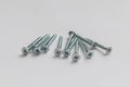 Handful of galvanized self-tapping screws on a white background Royalty Free Stock Photo