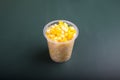 A handful of steamed corn in a transparent plastic container Royalty Free Stock Photo