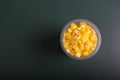 A handful of steamed corn in a transparent plastic container Royalty Free Stock Photo