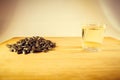 A handful of sunflower seed, sunflower oil in a glass on the table. Side view Royalty Free Stock Photo