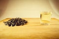 A handful of sunflower seed, sunflower oil in a glass on the table. Side view Royalty Free Stock Photo