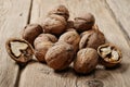 Handful walnuts on the wooden surface closeup