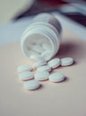 A handful of white large tablets on a peach background, vitamins Royalty Free Stock Photo