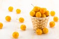 Handful of yellow cherry plums in basket
